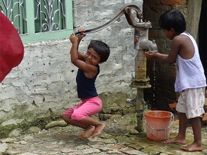 Boys pumping water image