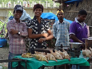 Young men selling chickens image