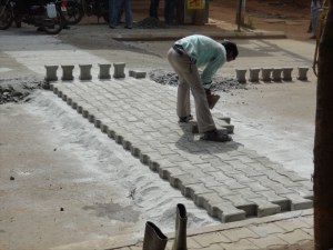 Man building a speed bump / crosswalk image