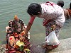 Woman placing flowers on altar